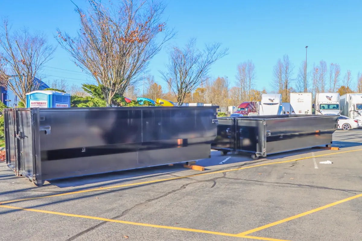 Professional dumpster rental service with roll-off container on residential driveway in Ocean